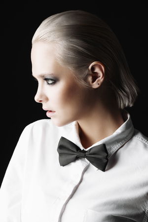 Beautiful female model with dark make-up posing at studio. Beauty, cosmetics concept.の写真素材