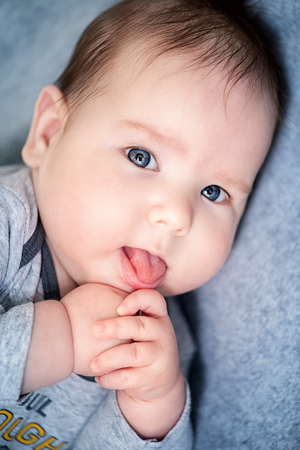 A portrait of a beautiful baby lying in the bed. Family, parenthood. Goods for newborns.の写真素材