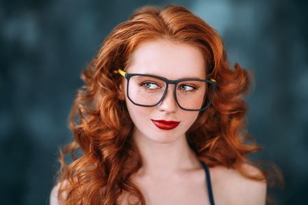 A close up portrait of a lovely mysterious girl in glasses. Beauty, cosmetics.の写真素材