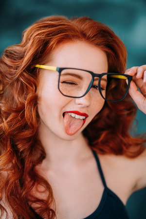 A close up portrait of a lovely emotional girl in glasses. Beauty, cosmetics.の写真素材