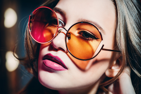 A portrait of a confident lady wearing sunglasses. Beauty, make-up, style.の写真素材