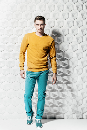 A full length portrait of a fashionable young man posing in the studio. Casual fashion for men.の写真素材