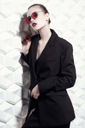 A portrait of a fashionable young lady posing in the studio over the white background. Style, beauty, spring fashion.の写真素材