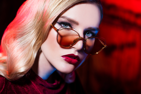 A close up portrait of a confident lady wearing glasses. Beauty, make-up, style.の写真素材