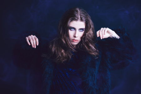A portrait of a beautiful gorgeous girl in black posing in the studio over the black background. Beauty, fashion.の写真素材