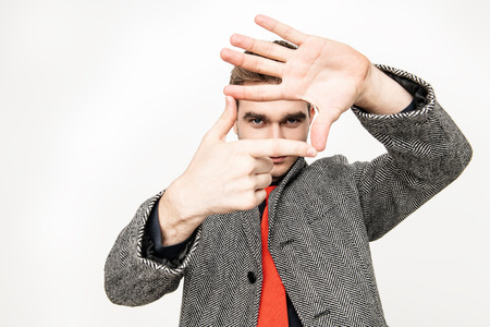 A portrait of a fashionable young man posing in the studio over the white background. Casual fashion for men.の写真素材