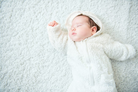 A portrait of a cute sleeping baby. Happiness, parenthood. Goods for newborns.の写真素材