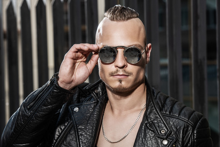 Portrait of a punk man on the street. Guy in the backyard. Fashion, subculture.の写真素材