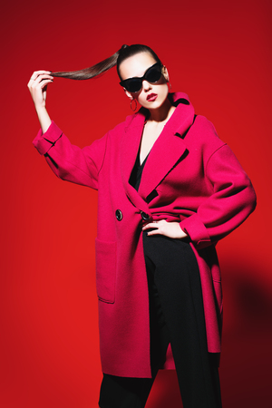 A portrait of a fashionable young lady posing in the studio. Style, beauty, spring fashion.の写真素材