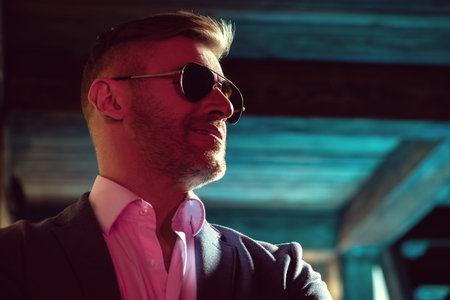 A close up portrait of a brutal handsome man in sunglasses. Men's beauty, fashion. Optics for men.の写真素材