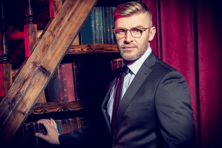 A close up portrait of a brutal handsome man in glasses. Men's beauty, fashion. Optics for men.の写真素材