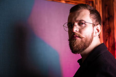 A portrait of a stylish man wearing glasses. Beauty and style for men.の写真素材