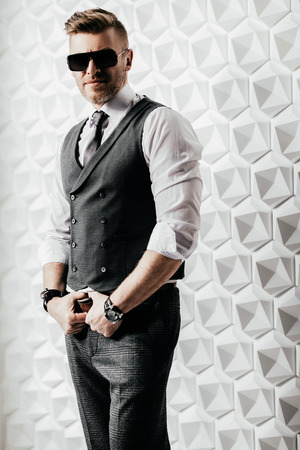 A portrait of a handsome brutal mature man posing in the studio over the white background. Casual formal fashion, men's beauty.の写真素材