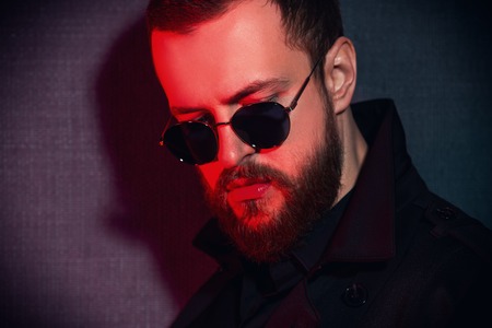 A portrait of a stylish man wearing sunglasses. Beauty and style for men.の写真素材