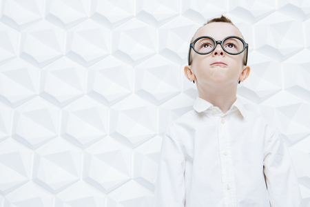 A portrait of a modern fashionable child boy posing in the studio over the white background. Kids, fashion, style, beauty.の写真素材