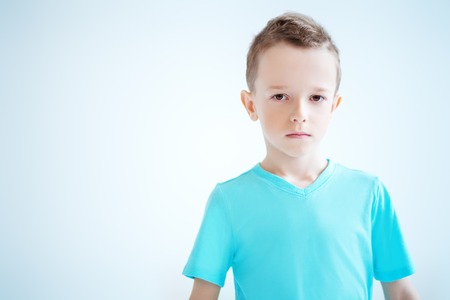 A portrait of a handsome child boy posing in the studio over the white background. Kids, fashion, casual style, beauty.の写真素材
