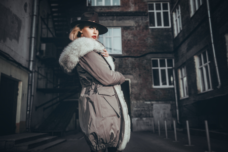 A portrait of a beautiful blonde lady walking in the street. Beauty, urban fashion, style.の写真素材