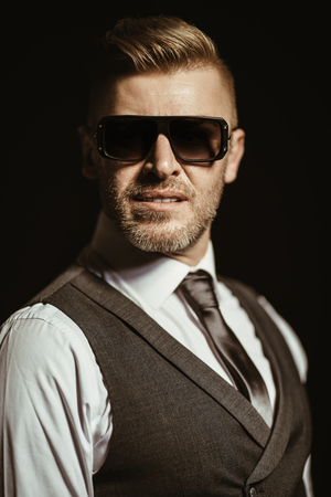 A portrait of a handsome brutal mature man posing in the studio. Casual formal fashion, men's beauty.の写真素材