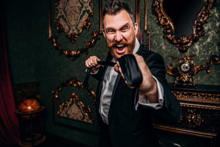 A portrait of an emotional adult man with a tie posing in the interior. Men's beauty, fashion,...