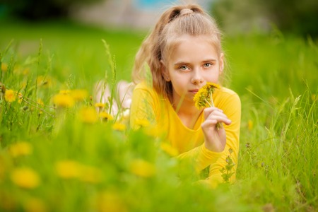 A portrait of a beautiful teenager girl posing in the field. Kids, nature, summer casual fashion, beauty.の写真素材