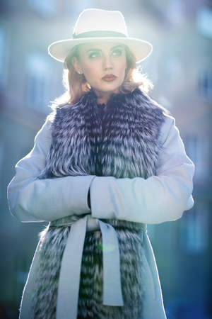 A portrait of a beautiful blonde lady walking in the street. Beauty, urban fashion, style.の写真素材