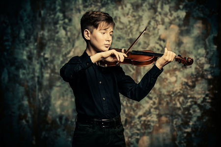 A portrait of a boy in his teens with the violin. A creative, talented, gifted boy.の写真素材
