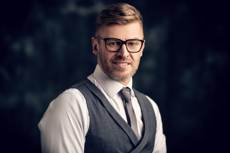 A close up portrait of a handsome brutal mature man posing in the studio. Casual formal fashion,...