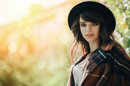 A portrait of a young fashionable woman in the park. Beauty, fashion.