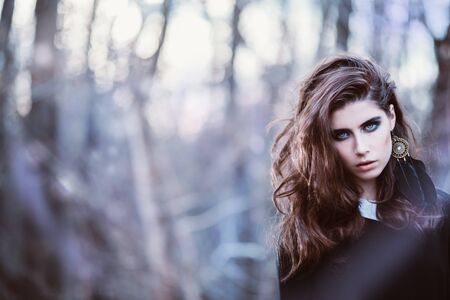 A portrait of a beautiful mysterious girl in black walking in the forest. Beauty, nature.の写真素材