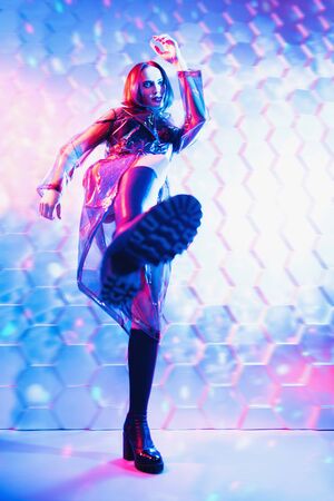 A full length portrait of an extravagant dark-haired lady. Modern fashion, beauty and style. Technologies, robots, artificial intelligence.の写真素材