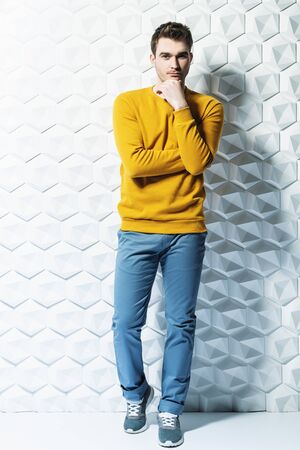 A full length portrait of a fashionable young man posing in the studio. Casual fashion for men.の写真素材