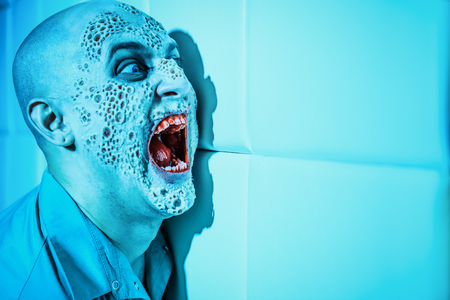 A portrait of a sick scientist after a failed experiment in the blue light. Desperation, hopelessness. Horror, halloween.の写真素材