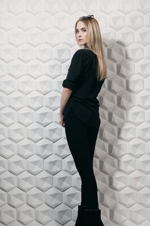 A full length portrait of a young lady posing over the white background in the studio. Style, beauty, fashion.の写真素材