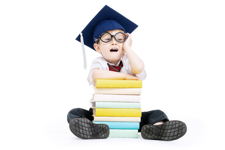 A portrait of a funny young schoolboy with books. Goods for pupils, education.の写真素材