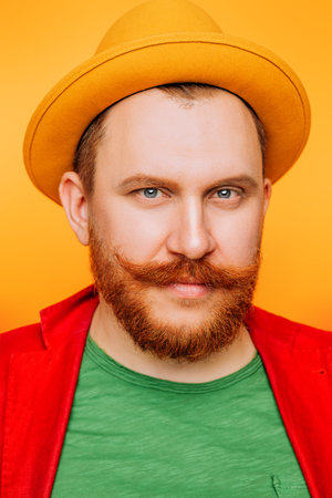 A portrait of a bright man posing in the studio over the yellow background. Men, beauty, colors,...