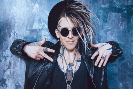 A portrait of a stylish punk man in the street. Modern men fashion.の写真素材