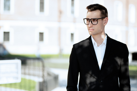 A portrait of a goodlooking young guy walking in the street. Men's beauty, fashion.の写真素材