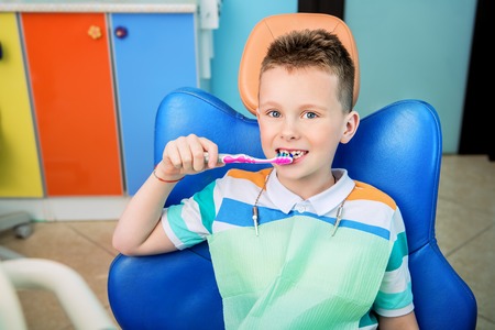 A portrait of a child boy in the cabinet of a dentist. treatment, medicine, hospital.の写真素材