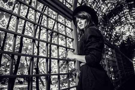 A black and white portrait of a young fashionable woman in the park. Beauty, fashion.の写真素材