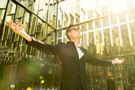 A portrait of a goodlooking young guy walking in the street. Men's beauty, fashion, business.の写真素材