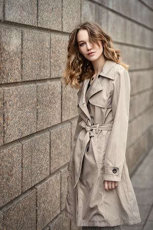 Beautiful young woman over urban background. Beauty, city fashion.の写真素材