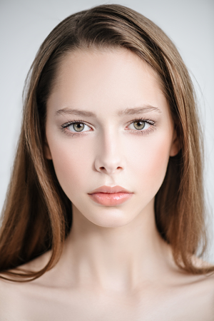A close up portrait of a pretty young girl posing in the studio over the white background. Beauty, cosmetics, skincare.の写真素材