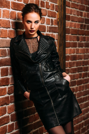 A portrait of a beautiful woman wearing a black leather jacket. Fashion, style.の写真素材