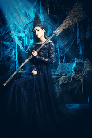 A beautiful lady in a costume of witch. Halloween. Celebration.の写真素材