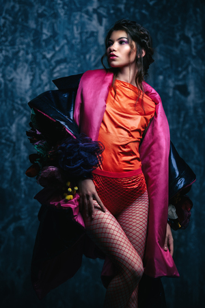 Vogue shot of a female model posing at studio. Fashion collection. Portrait over grunge background.の写真素材