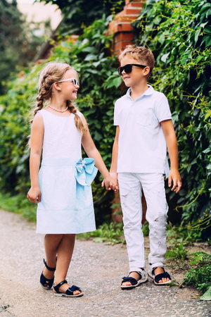 Children are walking in a park. Childhood, summer. Fashion concept.の写真素材
