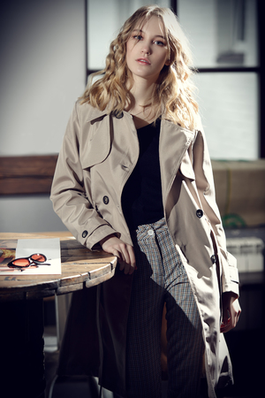 Beautiful young woman posing in a cafe.  Beauty, city fashion.の写真素材