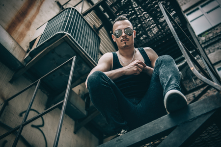 Portrait of a punk man on the street. Guy in the backyard. Fashion, subculture.の写真素材