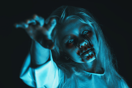 A portrait of a scary pale girl from horror film. Zombie, halloween.の写真素材