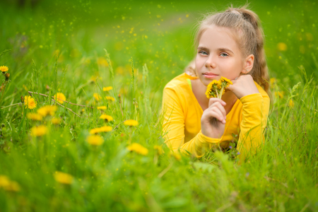 A portrait of a beautiful teenager girl posing in the field. Kids, nature, summer casual fashion, beauty.の写真素材